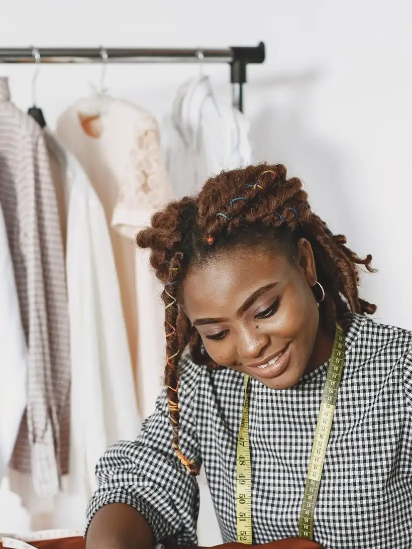 A seller smiling at her worktable