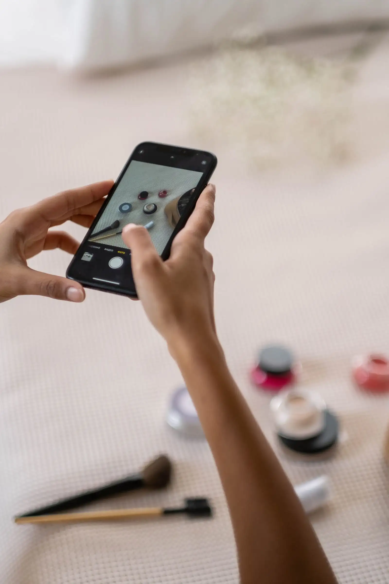 Hands taking a photo of products with a phone